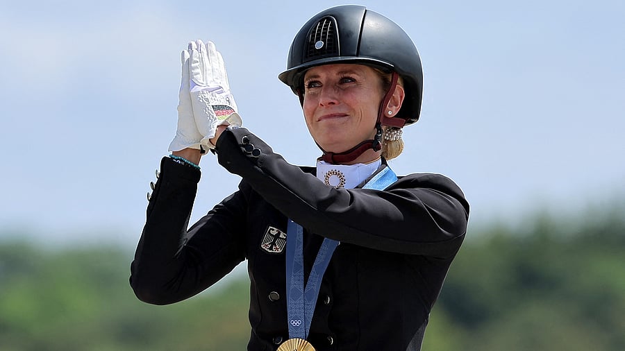 <div class="paragraphs"><p>Gold medallist Jessica von Bredow-Werndl of Germany celebrates on the podium with her medal.</p></div>